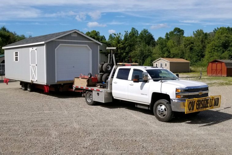 Yoder Building Company delivery truck with a shed on the trailer