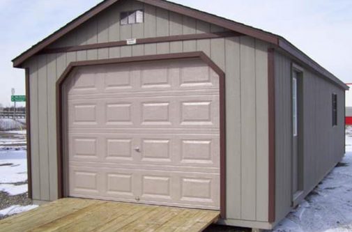 Gray Cottage Shed with a garage door by Yoder Building Company